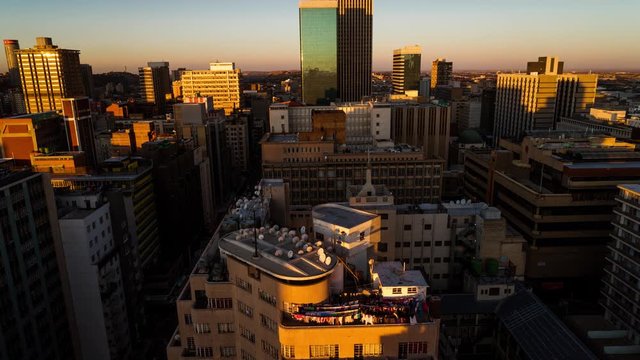 A sunset timelapse of the city centre of Johannesburg (CBD) with blue skies and shadows moving across showing the High Court of South Africa, old Sun International and Carlton Tower