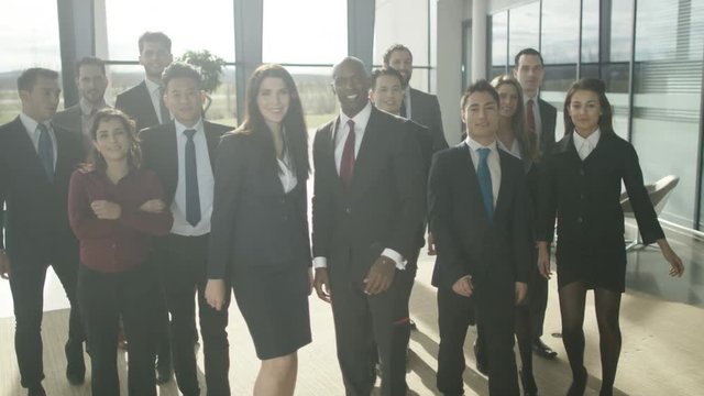  Portrait smiling diverse business group in large modern office building