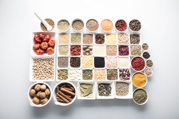 leguminous vegetables and spices in bowls, isolated on a white background