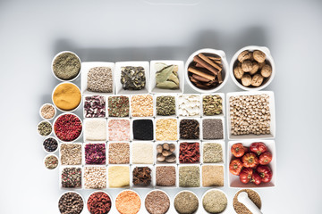leguminous vegetables and spices in bowls, isolated on a white background