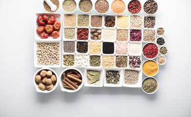 leguminous vegetables and spices in bowls, isolated on a white background