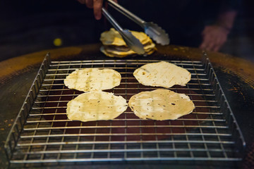 cooking background, grill naan bread on stove. Indian food, selective focus.