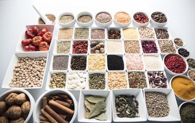 leguminous vegetables and spices in bowls, isolated on a white background