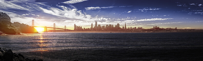 Panorama of downtown San Francisco and the Bay Bridge.  The urban view shows business district...