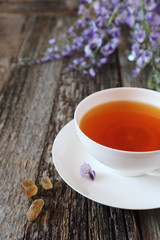 Summer tea drink: Flowering blue wisteria and cup of tea