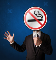 Businessman holding no smoking sign