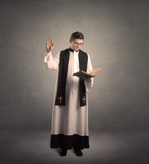 young priest in giving his blessing - obrazy, fototapety, plakaty