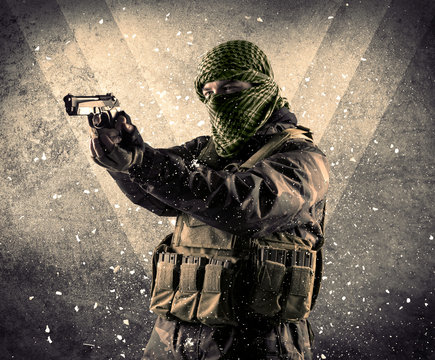 Portrait of a dangerous masked armed soldier with grungy background