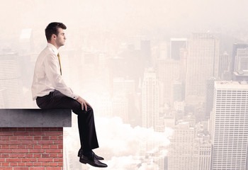 Office worker sitting on rooftop in city