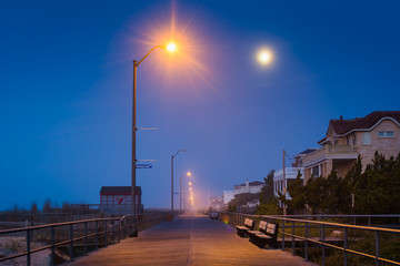 Moon over the boardwalk at night, in Ventnor City, New Jersey. © jonbilous