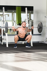 Athlete Doing Exercise For Legs With Barbell