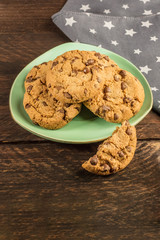 A teal plate of chocolate chips cookies with copyspace