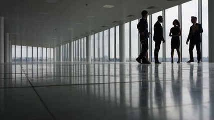  Business team viewing empty commercial property & shaking hands with agents