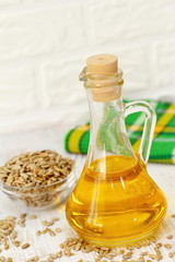 Sunflower oil in glass bottle and seeds