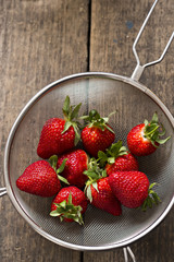 Fresh strawberries in metal strainer