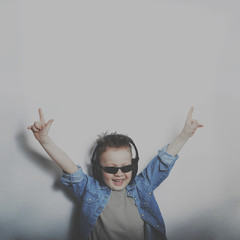 boy rocker in dark glasses raised his hands up. hard rock