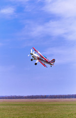 Flight of a sport aircraft against a blue sky.