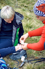 Hiking in the mountains, helping the girl on the spot.