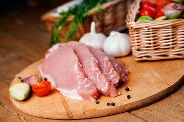 Slices of raw pork meat and vegetables 