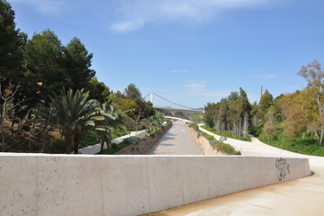 Bridge of wood and concrete leading to the sea and the park