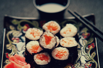 Sushi rolls with salmon, soy sauce and chopsticks 