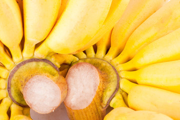 hand of Golden bananas  on white background healthy Pisang Mas Banana fruit food isolated
