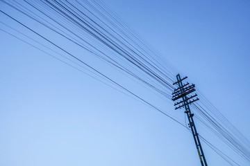 electricity post with wire in clear blue sky