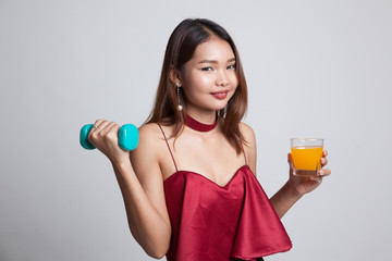 Young Asian woman with dumbbell drink orange juice.