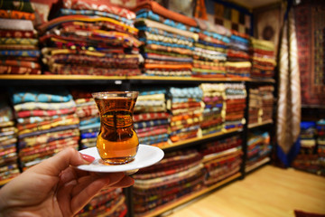 A glass of Turkish tea against the background of Turkish textiles. Turkey, Istanbul.