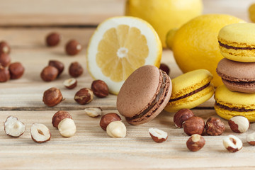 Yellow and brown french macarons with lemon and hazelnuts