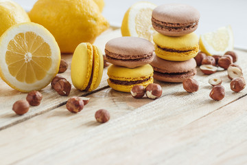 Yellow and brown french macarons with lemon and hazelnuts