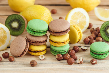 Green, yellow and brown french macarons with lemon, kiwi and hazelnuts