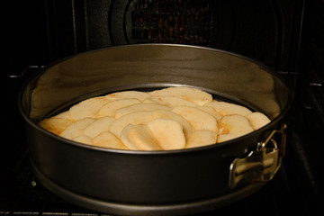 Apple pie with apple slices in an oven