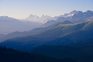 The first rays of the sun illuminate the mountain in the Western Caucasus