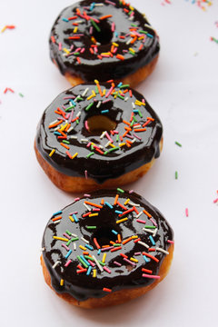 Lush donuts with chocolate icing and bright sprinkles
