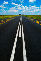 Long road ahead beneath a blue sky