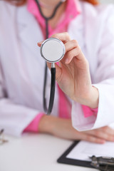Doctor with a stethoscope in the hands. Pink colored scene