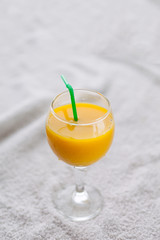 Pineapple, orange juice in a glass with a straw, juice for healthy nutrition