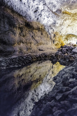 Quiet water reflection on a rock cave