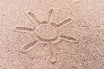 Sun painted in the sand on the beach