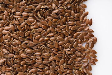 close up of flax seeds isolated on white background. Bowl full of brown flaxseed or linseed. Cereals. Vitamins. Healthy food.