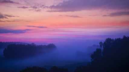Fototapeta na wymiar Misty landscape in the break of dawn