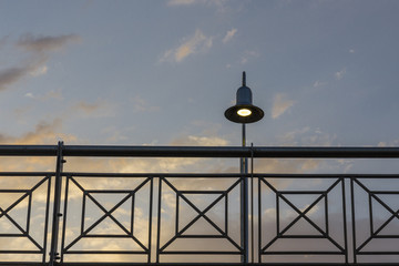 Handrail with different lines and geometric forms and a lamp at sunset light