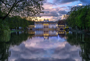 Pałac na Wyspie, Łazienki Królewskie. A Neoclassicist palace in Warsaw - an evening view with a cloudy reflection.