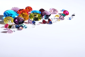 Colorful of different gemstones with space for text on white background.