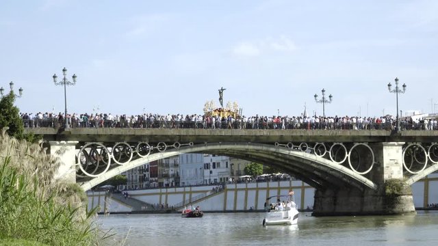 SEVILLE, SPAIN - APRIL 14: Traditional procession on the Triana Bridge. April 14, 2017 in Seville, Spain.