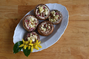Champignons stuffed with a mixture of cheese and salami.