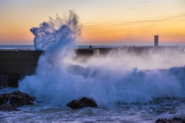 Fototapeta na wymiar Big waves smashes on breakwater in Porto, Portugal