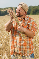 Farmer in cap standing at field