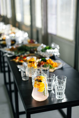 Lemonade and glasses on a black table. Festival. Stylish kitchenware